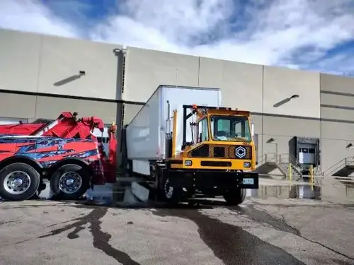 Heavy towing equipment recovering a dropped commercial trailer