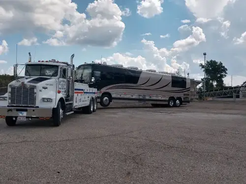 Heavy wrecker towing a commercial motorcoach
